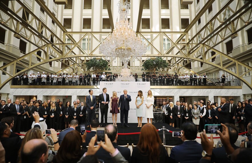 Then Republican presidential candidate Donald Trump (center) and his family prepare to cut the ribbon at the new Trump International Hotel on Oct. 26, 2016, in Washington, D.C.