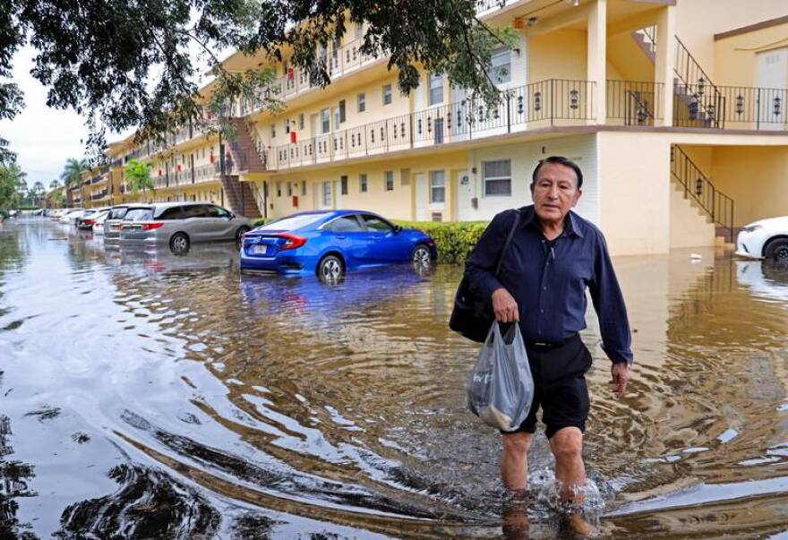 Man walks through flooded road