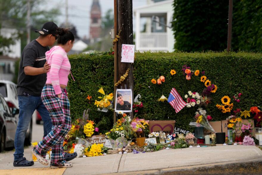 Local residents walk by a makeshift memorial to the victim of a shooting involving U.S. Immigration and Customs Enforcement, Tuesday, July 14, 2026 in Biddeford, Maine. (Robert F. Bukaty/AP)