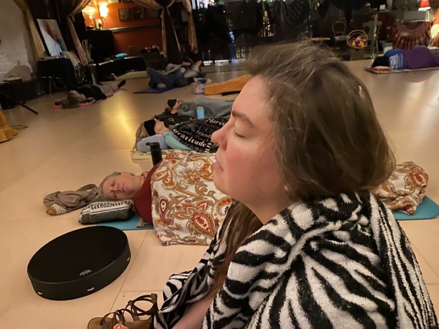 Participants in this evening's sound bath start the session with a meditation