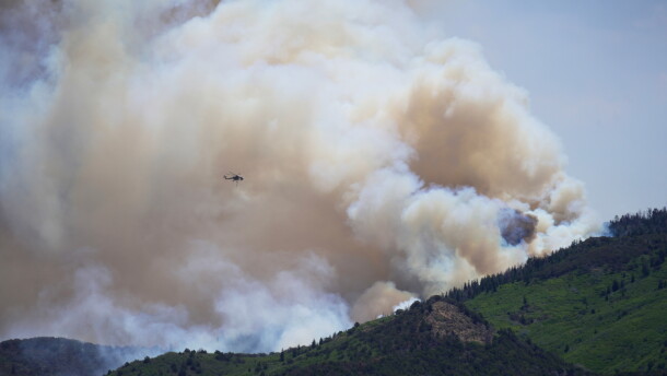 A helicopter flies near the Cottonwood Fire in Beaver, Utah, Tuesday, June 30, 2026. (AP Photo/Ty ONeil)