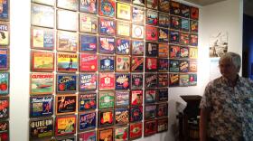 Bill Rietveldt, Wenatchee Valley Museum & Cultural Center curator, shows off apple labels. “The great northern railroad advertised Wentachee as ‘The Place to Go Grow Apples,” Rietveldt said. “That’s why people came here.” Photo credit: Tony Schick