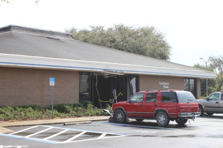 The entrance at SunTrust Bank in Sebring were still bashed in a day after the shooting from when a police vehicle had to break down the barricaded doors.