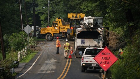 Workers try to clean the route impacted by recent storms and flooding on Monday, July 17, 2023. Belvidere, New Jersey. (AP Photo/Eduardo Munoz Alvarez)