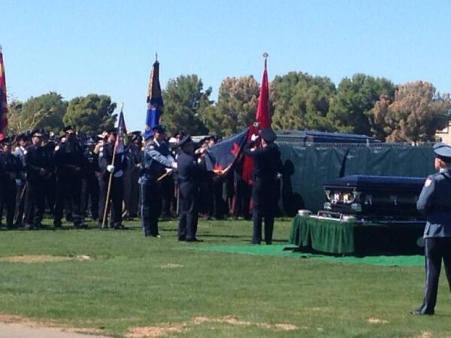 Chief Garcia of the Phoenix Police sadly places another streamer. Each one represents a fallen officer, too many to count.