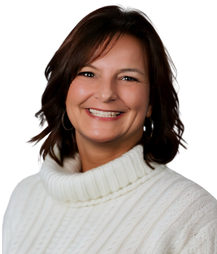 A smiling woman with shoulder-length brown hair wearing a white turtleneck sweater