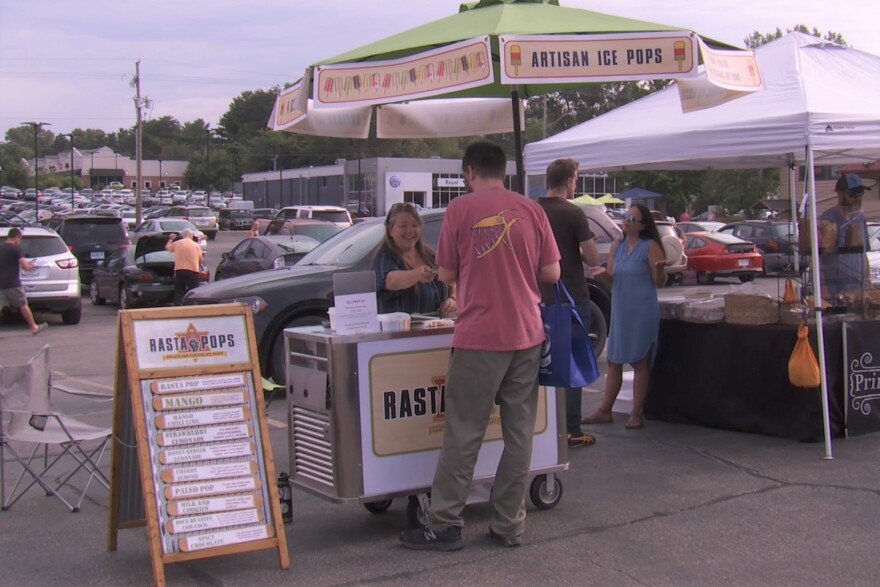Linda Lewis interacts with a customer at her Rasta Pops cart at the 'Hate-Free Farmers Market,' Aug. 17, 2019.