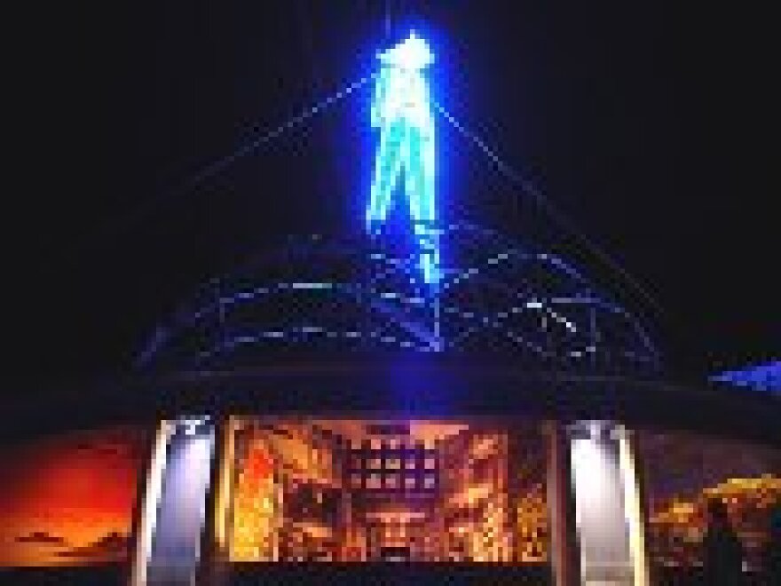 The 40-foot Man stands on a 40-foot dome at the 2004 Burning Man festival in Nevada's Black Rock Desert.