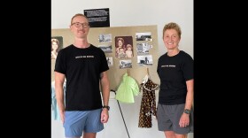 James Sanders (left) and Dena Sanders (right), the children of Janis Sanders, stand in front of a poster board with family photos and baby clothes at an event held in Niles on July 19, 2025. Now 52 and 55, the siblings continue to search for answers about their mother's disappearance and advocate for investigative efforts around cold cases in Michigan.