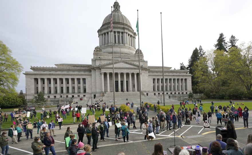 People demonstrating in favor of abortion rights gather during an evening rally, Tuesday, May 3, 2022, at the Capitol in Olympia, Wash. (AP Photo/Ted S. Warren)