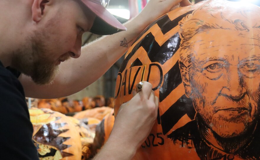 Artist Josh Bleecker carving a pumpkin portrait of late filmmaker David Lynch