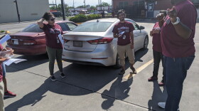 Derek Taylor (right) instructs his team.