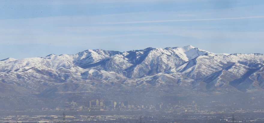 In this Dec. 14, 2018, photo, an inversion settles over Salt Lake City. Inversions hover over Salt Lake City as cold, stagnant air settles in the bowl-shaped mountain basins, trapping tailpipe and other emissions that have no way of escaping to create a brown, murky haze the engulfs the metro area. Doctors warn that breathing the polluted air can cause lung problems and other health concerns, especially for pregnant women and people with respiratory issues. (AP Photo/Rick Bowmer)