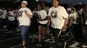 Evelyn Brady (right) leads a run to honor her son, Mohammed Haitham, who was killed in a mass shooting at the Pensacola Naval Base. Kerry Sheridan/WUSF 