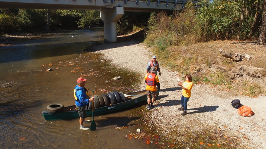 Volunteers pulling discarded tires from the Little Miami River.