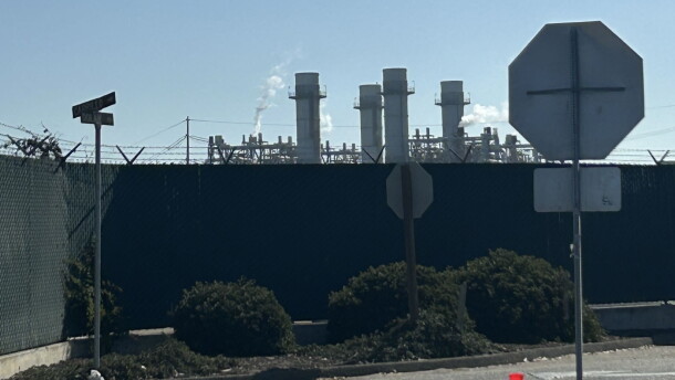 Smoke rises above industrial towers