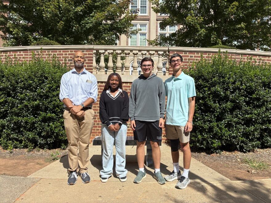Civic Literacy Teacher Cristofer Wiley (left) stands with Reynolds High School students Tandy Adjei, Grant Cameron and Patrick Rais-Bahrami 