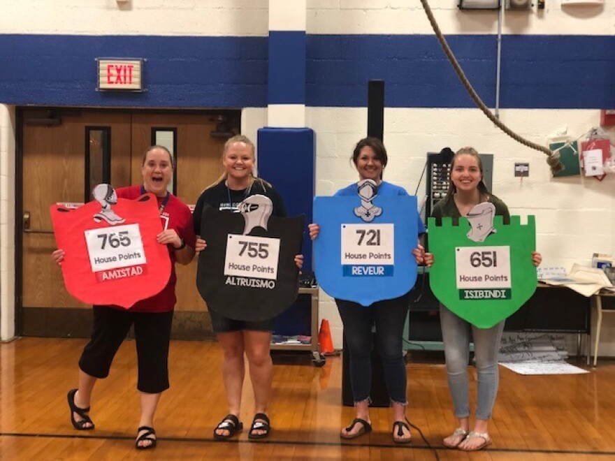 Teachers hold up color signs