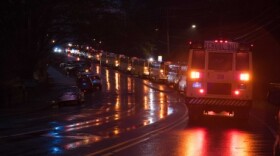 Buses in line waiting to pick up students from Reynolds High School and transport them to a parent meetup location at the Harris Teeter on Cloverdale Ave.