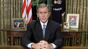 Former President George W. Bush sits at his desk in the Oval Office after addressing the nation about the terrorist attacks on New York and Washington, DC Sept. 11, 2001 in Washington, DC. (Mark Wilson/Getty Images)