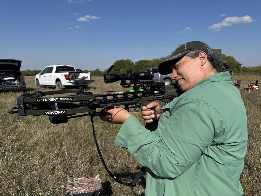 Enfield, director of outreach at the  Kansas Association for Conservation and Environmental Education, aims a crossbow at a target. She hit the bull’s eye with both of her first ever shots. Enfield and her fellow Wild Foods Academy graduates committed to becoming wild foods instructors.
