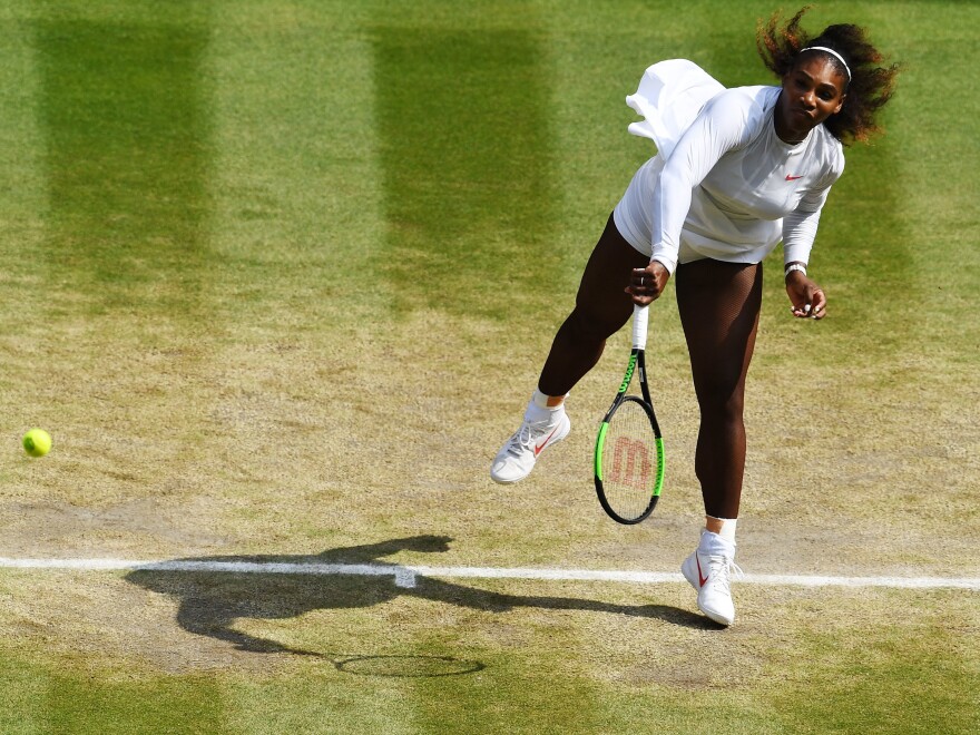 Serena Williams of The United States serves against Julia Goerges of Germany during their Ladies' Singles semi-final match on day 10 of Wimbledon on July 12, 2018 in London.