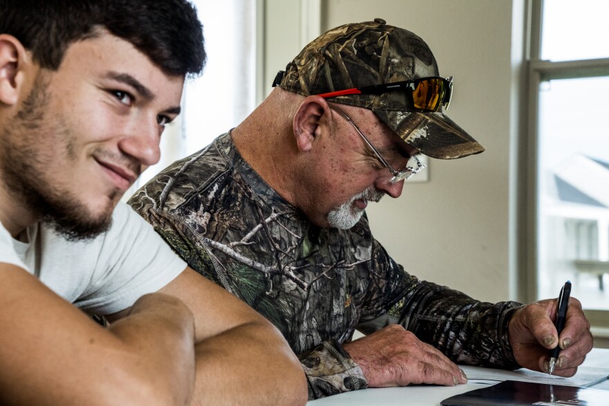 Chris Brunet and his nephew Howard Brunet go over the home ownership documents on Wednesday, August 24.