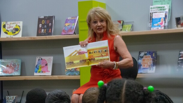 Maureen Braun, Governor Mike Braun's wife, reads from The Little Engine That Could to a group of children in the playscape inside the Allen County Public Library's main branch on Wednesday. Most of the children were members of the Fort Wayne Boys and Girls Club visiting the library, with a few library patrons joining them.