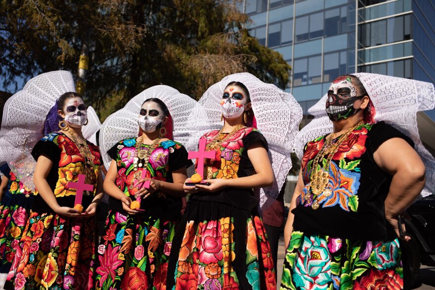 Participants of the event are decked in traditional folkloric clothing and headdresses to honor the Day of the Dead in downtown Dallas, on Sun., Nov. 1, 2020.