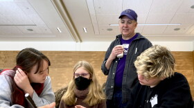 Ballard High School Teacher Shawn Lee watches over students looking over school work.