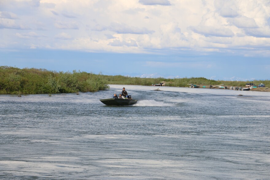 A boat rides down a river near Quinhagak.