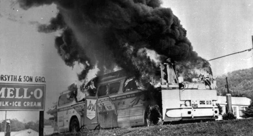 FILE - This is a May 1961 file photograph of a Freedom Rider bus that went up in flames when a fire bomb was tossed through a window near Anniston, Ala. Crews broke ground Thursday, Oct. 18, 2012 on a park aimed at illustrating the violence as well as the hope embodied following a 1961 attack on civil rights workers. The groundbreaking was held Freedom Riders Park in the Anniston area. The park commemorates a brutal attack on civil rights activists 51 years ago and the progress made since then. (AP Photo/File)