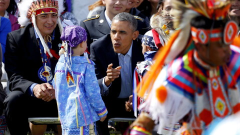 President Barack Obama talks to two young boys during a Native American dance on the Standing Rock Indian Reservation Friday, June 13, 2014, photo in Cannon Ball, N.D.