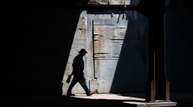 A man walks along a street in Lawrence on August 16, 2019. (Spencer Platt/Getty Images)