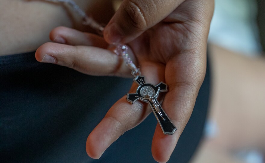 Genesis Espinoza Sierra holds a rosary that was hanging from the rearview mirror of her brother Edilberto Espinoza Sierra's car at their family's home in Wallace on April 17, 2026. Edilberto Espinoza Sierra was shot and killed by the Wilmington Police Department in the early morning hours of March 8 following an incident in a downtown Wilmington parking garage. Espinoza Sierra was incorrectly identified as a suspect before he was killed and now his family is seeking answer and accountability.