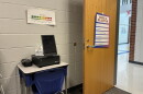 School office with desk and computer screen used for telehealth 