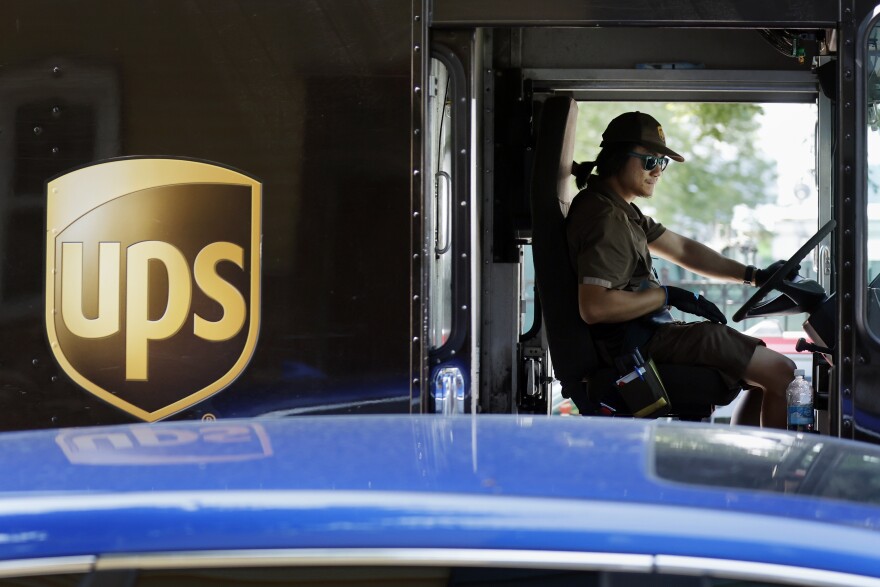 A United Parcel Service delivery driver steers his truck, Friday, June 30, 2023, in the East Boston neighborhood of Boston. Frustrated by what he called an "appalling counterproposal" earlier this week, Teamsters General President Sean O'Brien, the head of the union representing 340,000 UPS workers, said a strike now appears inevitable and gave the shipping giant a Friday deadline to improve its offer. (AP Photo/Michael Dwyer)