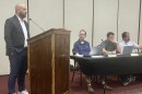 Justin Paul, representing the Florida-based property management firm for the Cherry Tree Plaza shopping center in Washington, answers a question Monday from a Washington City Council member.