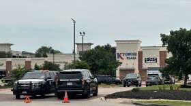 Law enforcement cars parked in a plaza with a sign that reads "K Towne Plaza."