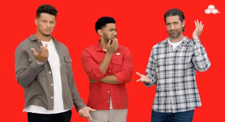 NFL quarterbacks Patrick Mahomes, left, and Aaron Rodgers, right, with Jake From State Farm appear in an online ad.