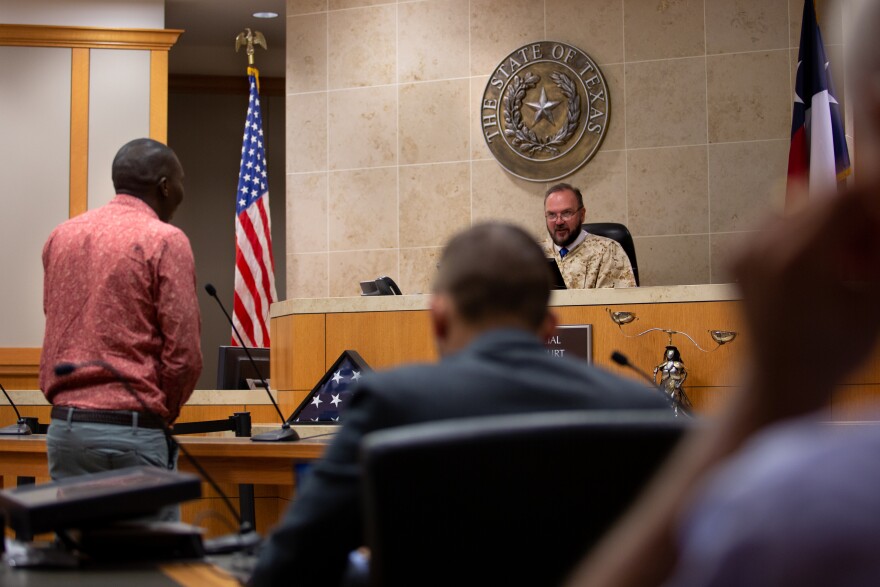 A veteran stands before Judge Roach, sharing his progress within the program thus far.