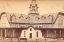 A black and white photo of a large wooden building.