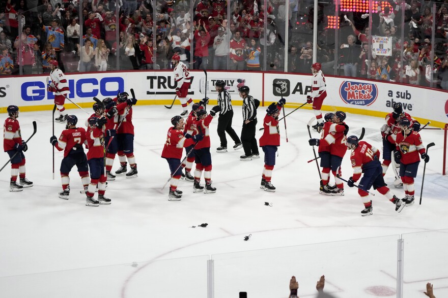 The Florida Panthers congratulate one another after defeating the Carolina Hurricanes in Game 4 of the NHL hockey Stanley Cup Eastern Conference finals Wednesday, May 24, 2023, in Sunrise, Fla.