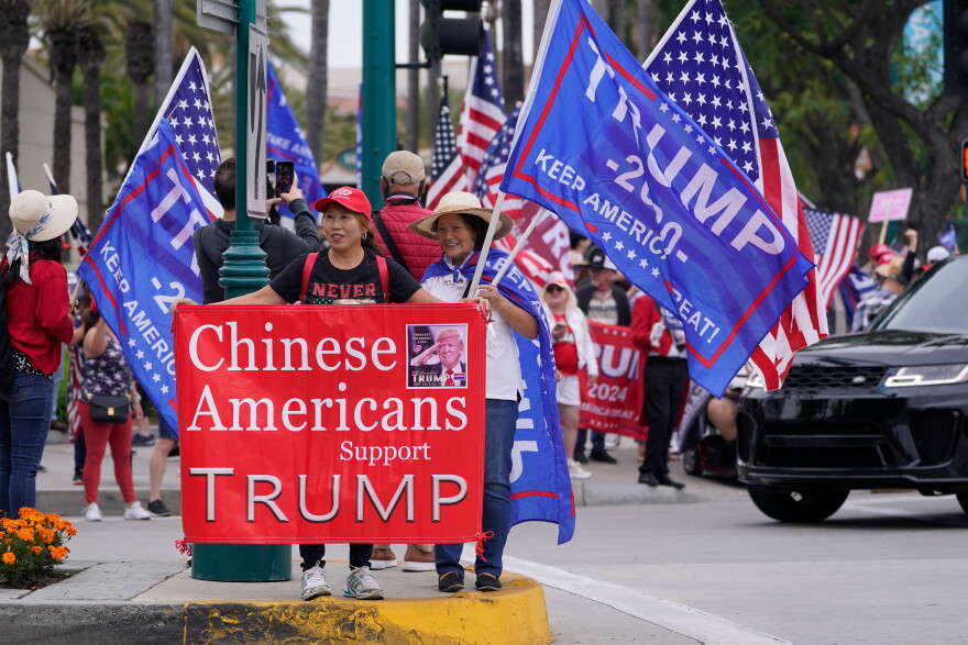 FILE - Chinese Americans supporters of former President Donald Trump stand outside the hotel where the 2023 Fall California Republican Convention is being held in Anaheim, Calif., Sept. 29, 2023. (AP Photo/Damian Dovarganes, File)