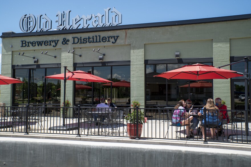 Patrons dine at the Old Herald Brewery and Distillery in Collinsville on May 29. The restaurant can serve customers in-person outside in phase three of Illinois' reopening plan.