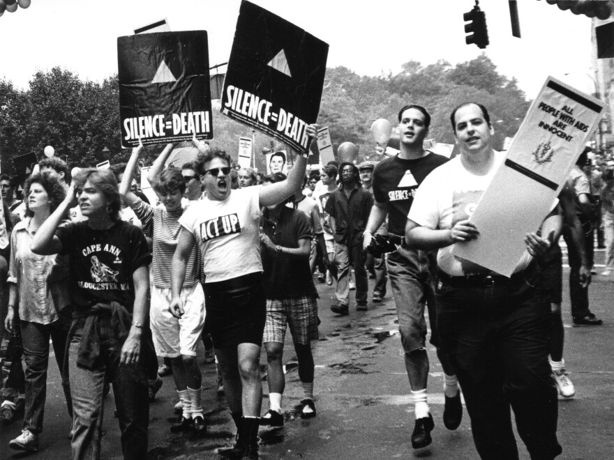 Members of ACT UP hold up signs and placards during the Gay and Lesbian Pride march in New York City, June 26, 1988.