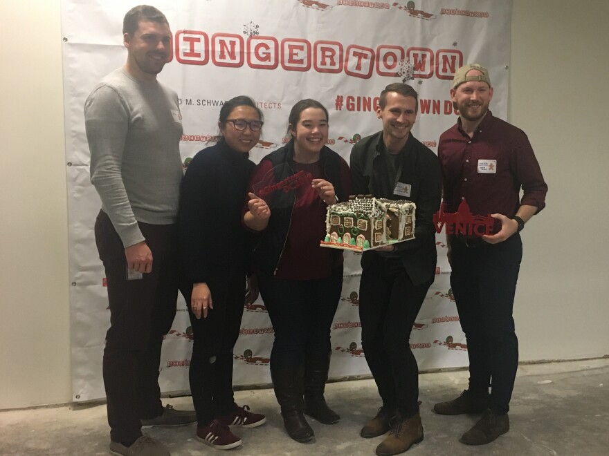 CannonDesign presents their finished Venetian gingerbread building before carrying it down to the lobby. From left to right: Max Hurley, Cheng Gao, Christen Fairley, Daniel Olberding and Hunter Young.