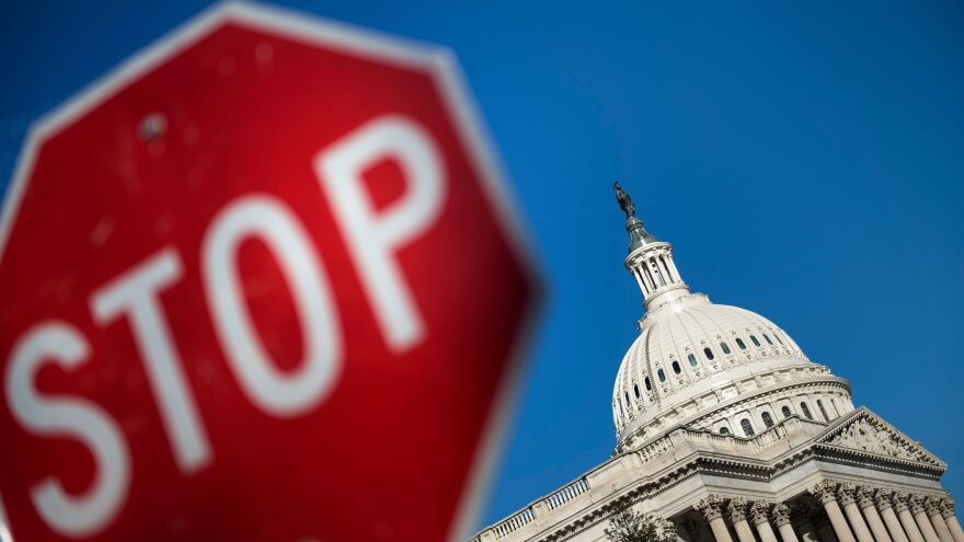 Capitol Hill is seen against a blue sky Saturday, the first day of the partial government shutdown.