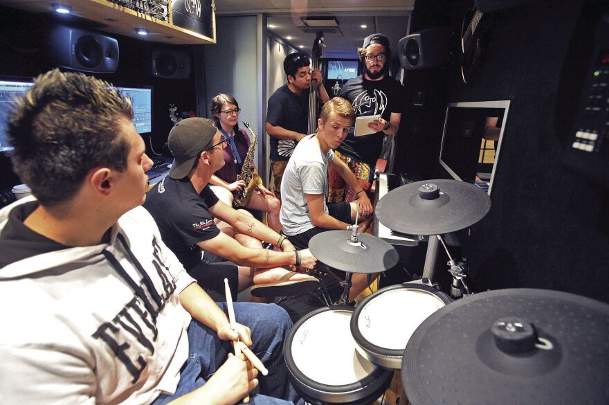 Pocatello High School Students rehearse their song on the Bus