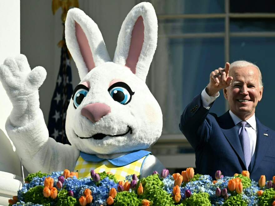 President Biden, alongside the Easter Bunny (L), gestures after speaking at the annual Easter Egg Roll.